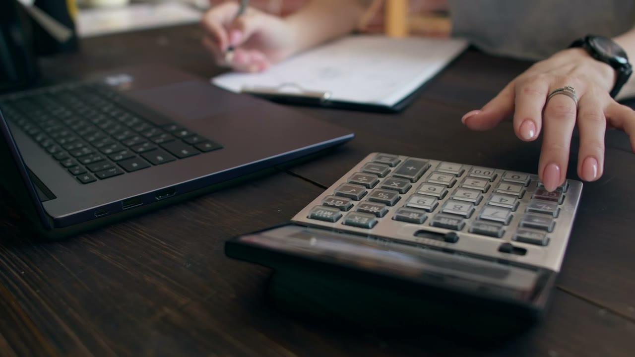 Accountant working at her desk with a calculator